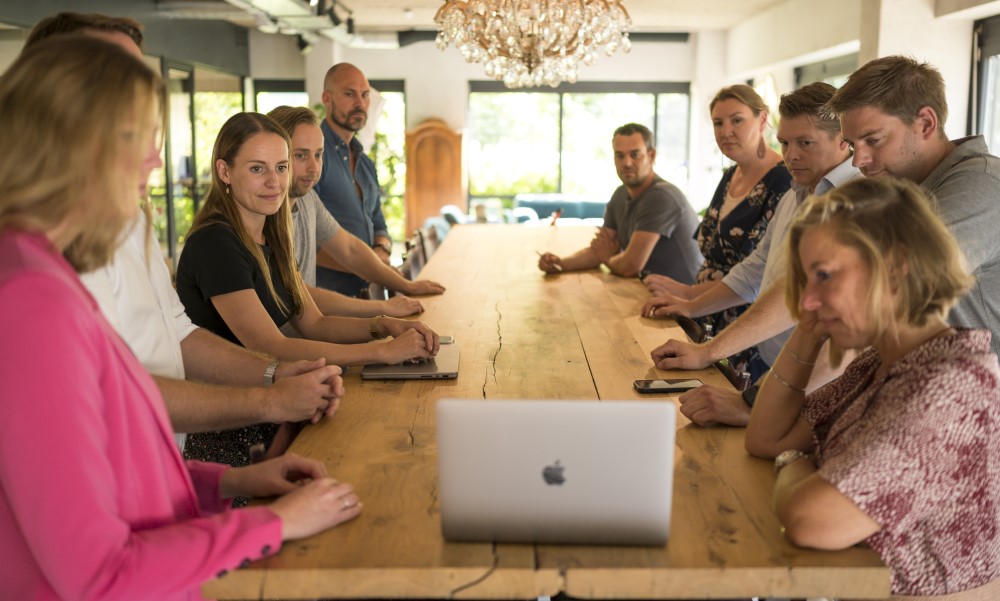 A Scrum Team event with people standing behind a table